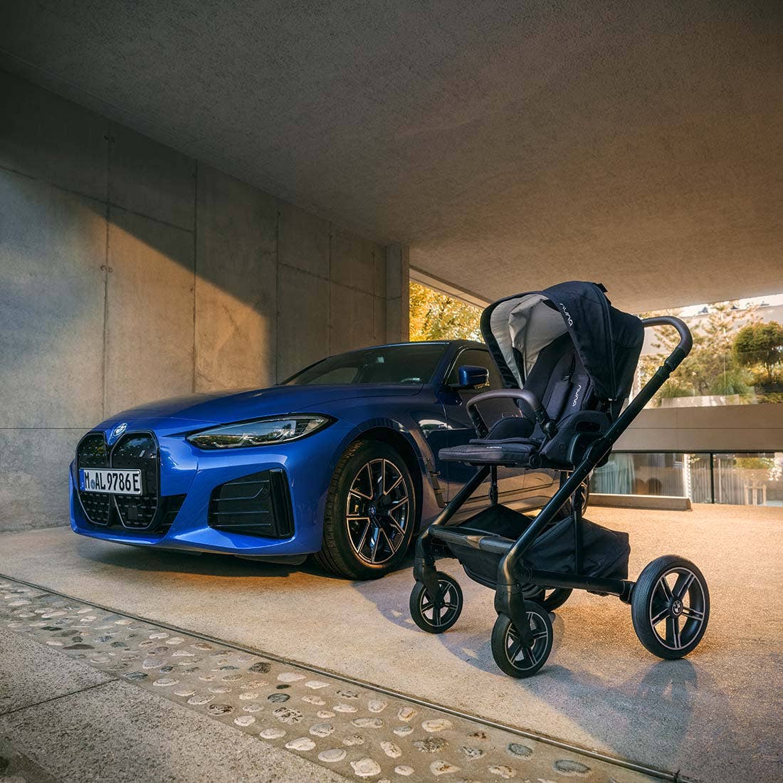 Nuna MIXX next Stroller — black stroller in side profile beside a blue car