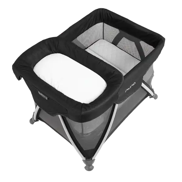Nuna SENA Changer — SENA Changer attached to a compatible playard