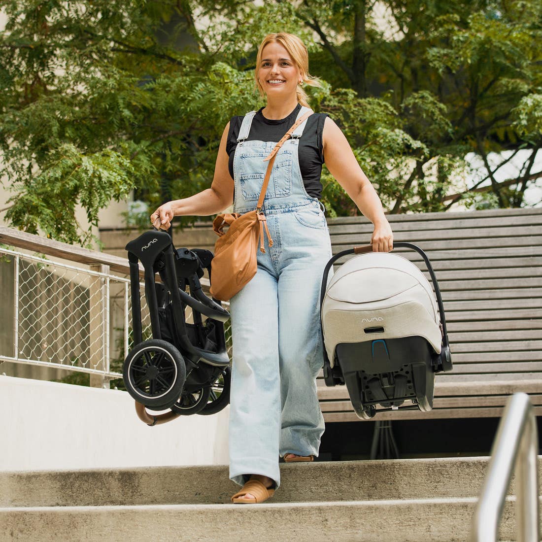 Nuna TRIV next Stroller — folded stroller carried up outdoor steps