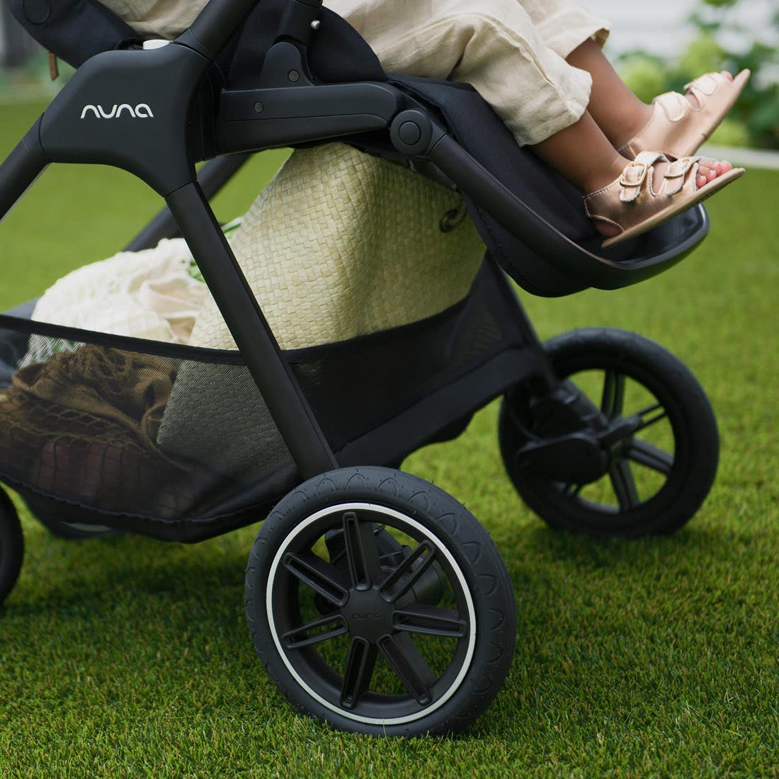 Nuna TRIV next Stroller — rear wheels and underseat basket in use