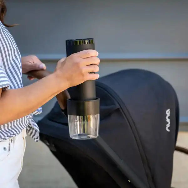 Nuna TRIV Series Cup Holder attached to a stroller