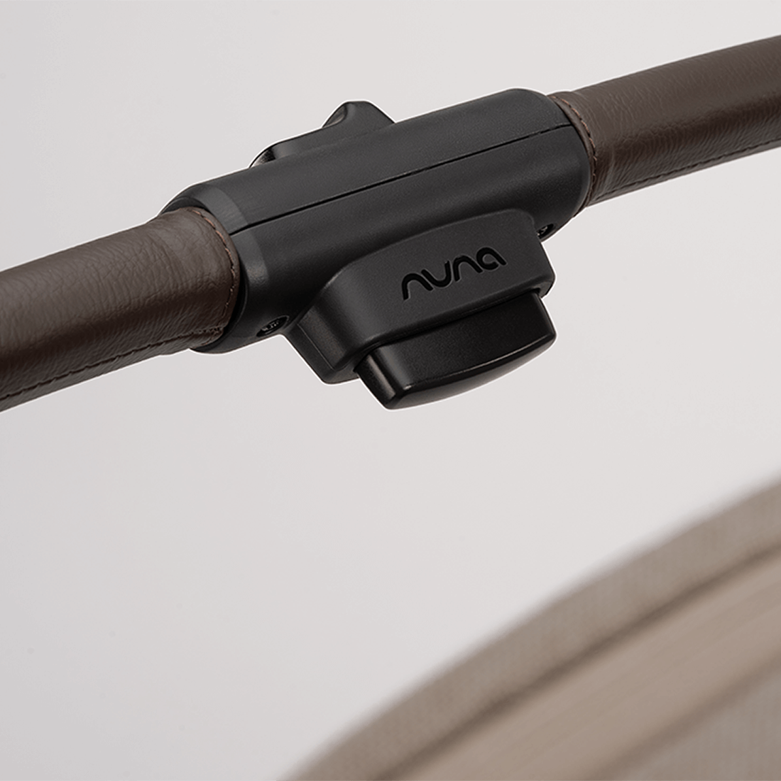 Nuna TRVL dubl Stroller — Cedar folding button on pushbar