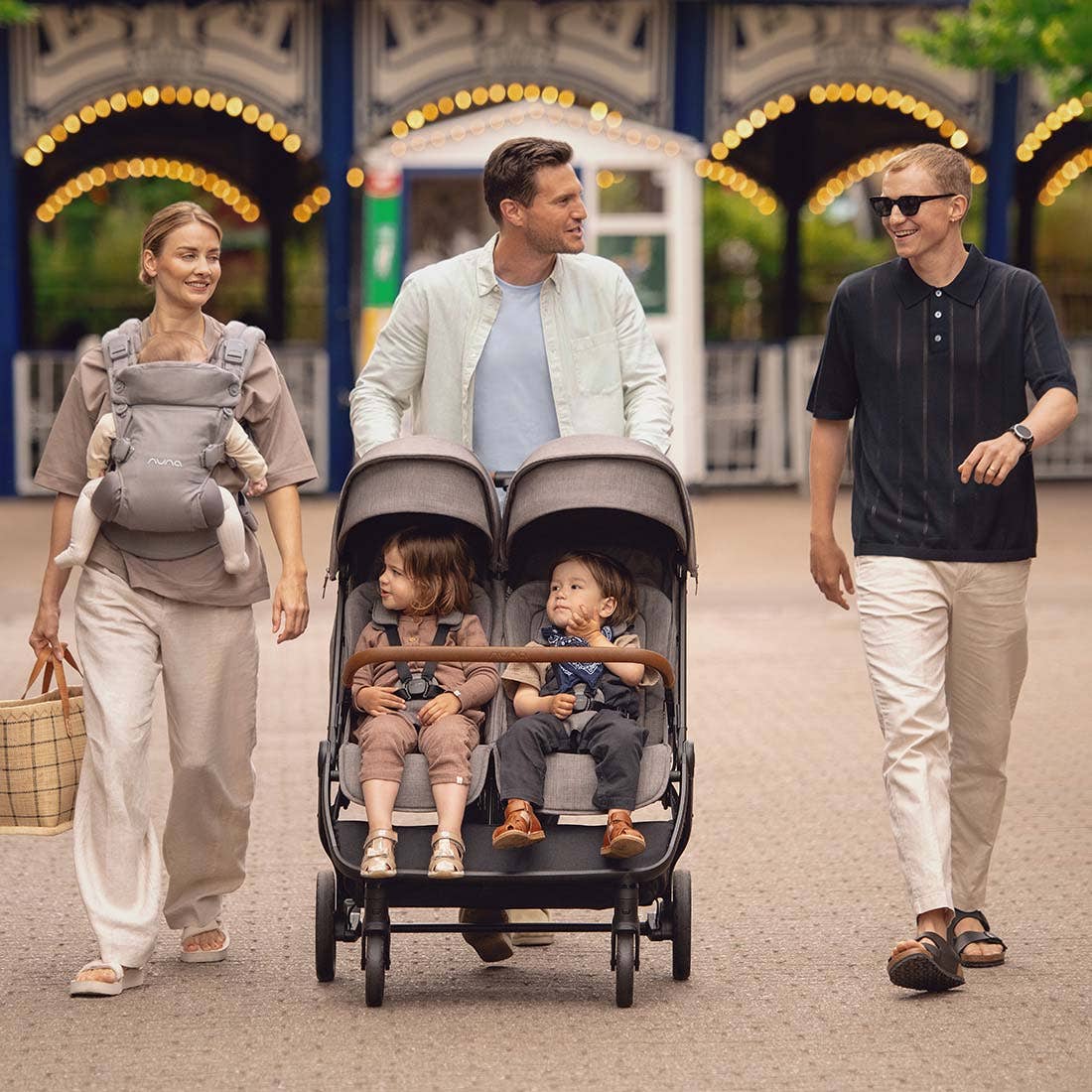 Nuna TRVL dubl Stroller — family stroll at an amusement park