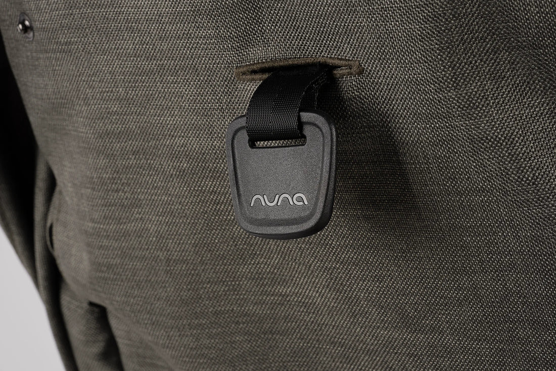 Nuna TRVL LX stroller in Granite, rear seat adjustment strap close-up