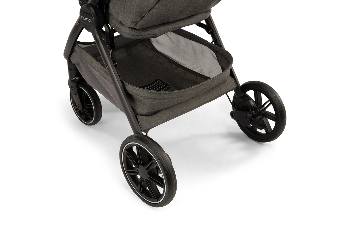 Nuna TRVL LX stroller in Granite, front wheels and underseat basket detail