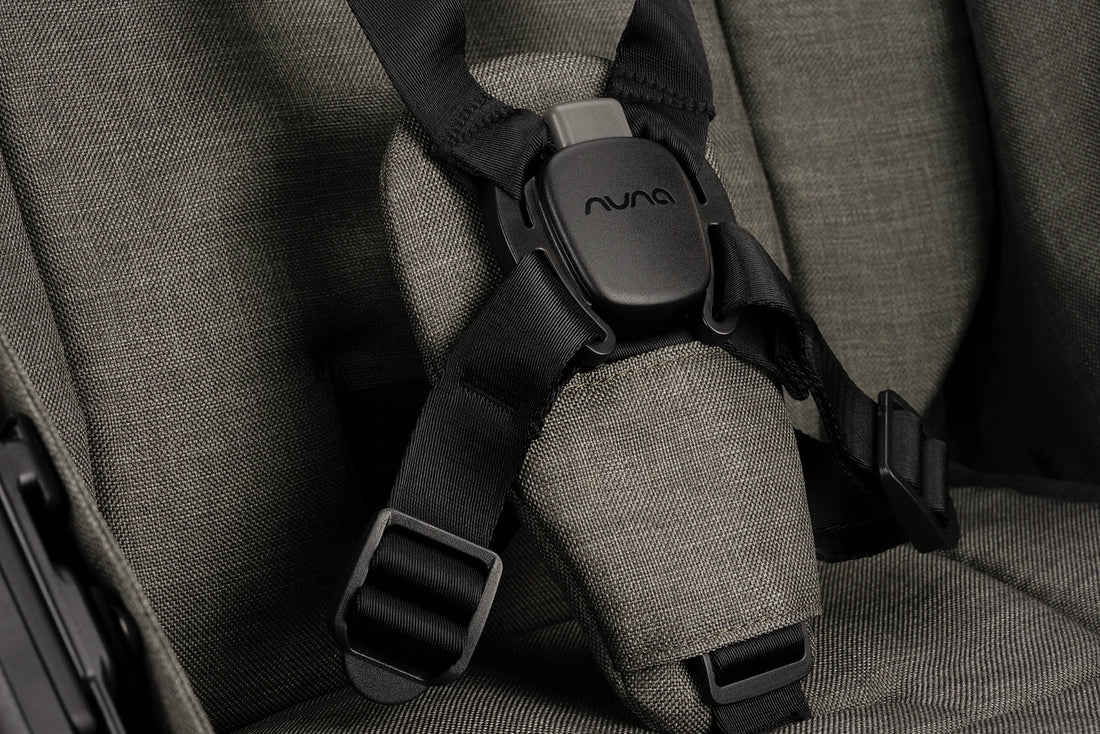 Nuna TRVL LX stroller in Granite, harness and magnetic buckle close-up