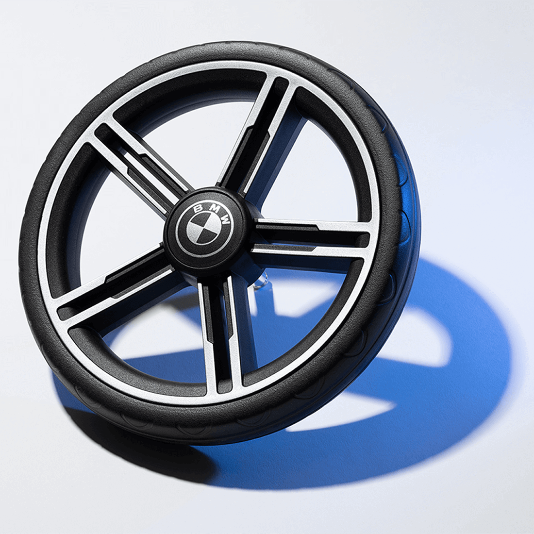 Nuna TRVL lx Stroller — Mica BMW Collection front wheel with emblem