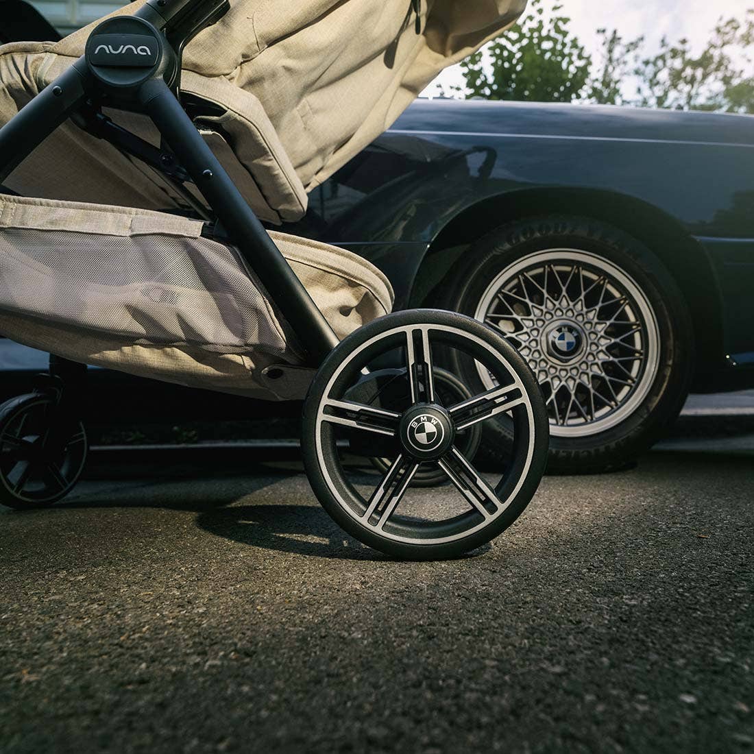 Nuna TRVL lx Stroller — Mica BMW wheel beside car wheel