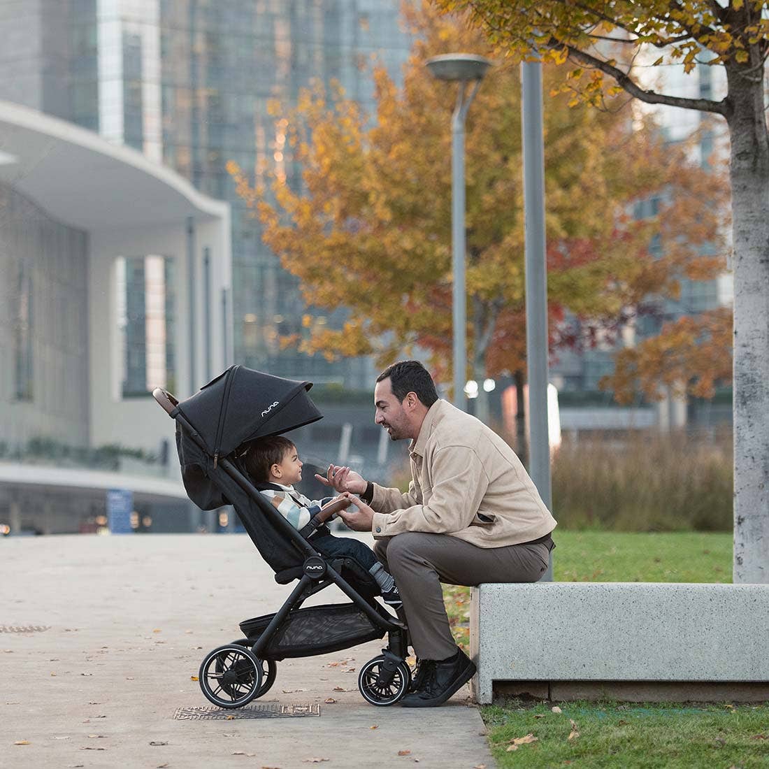 Nuna TRVL lx Stroller — parent seated beside child in stroller