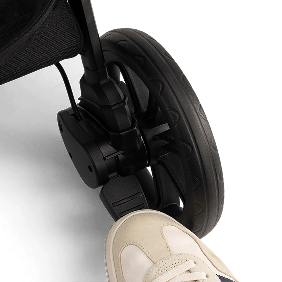 Nuna TRVL LX Stroller + PIPA Urbn Infant Car Seat Travel System showing Nuna TRVL lx Stroller — Caviar brake pedal from alternate angle