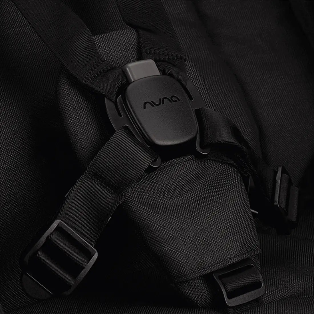Nuna TRVL LX Stroller + PIPA Urbn Infant Car Seat Travel System showing Nuna TRVL lx Stroller — Caviar MagneTech buckle close-up