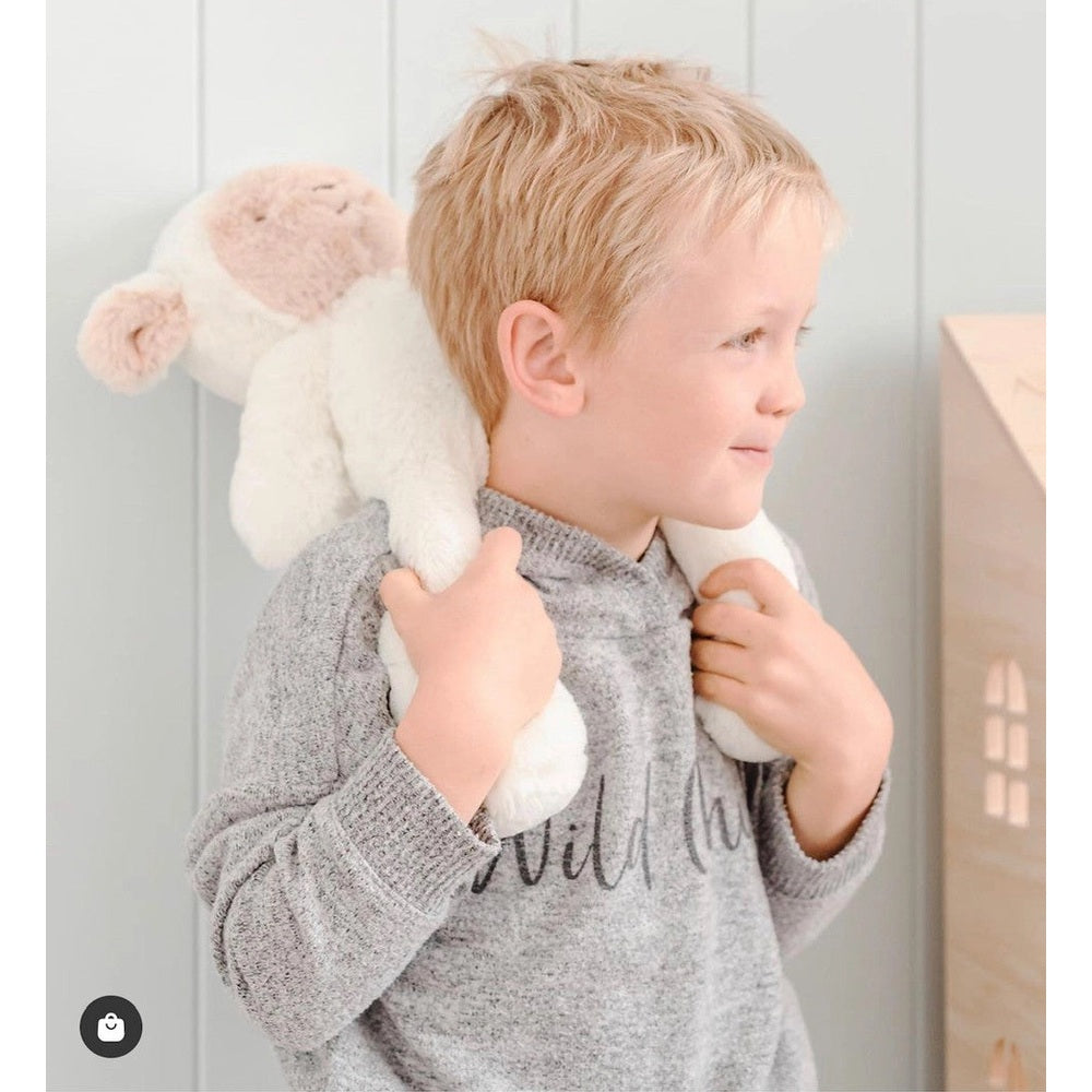 OB Designs Lee Lamb soft toy, medium 34cm, cream plush carried by toddler