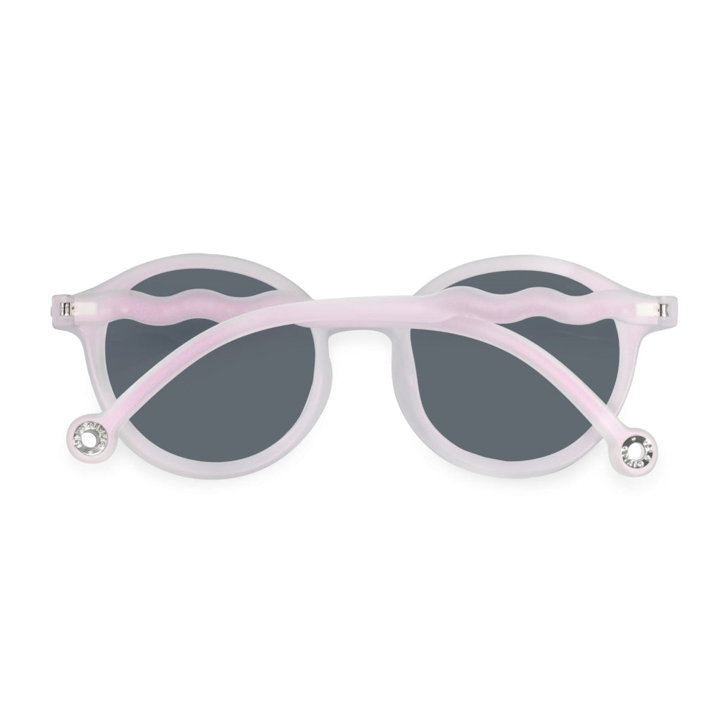 Olivio & Co Oval Sunglasses Adult in pink shimmer with gray lenses; wavy pink temples ending with rhinestone tips