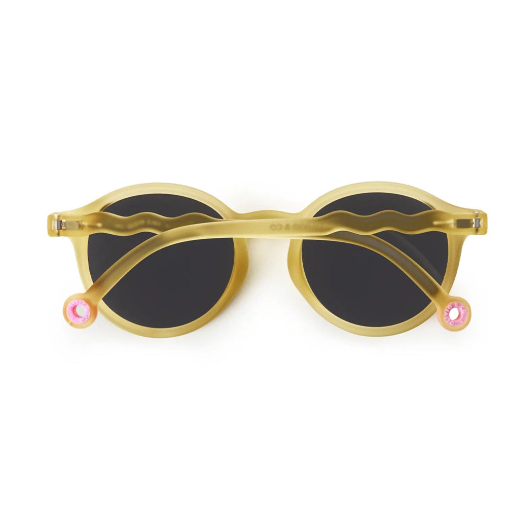 Olivio & Co Oval Sunglasses Junior+ Classic Olivio Sun Coral with gold frames and black lenses, shown flat to highlight shape.