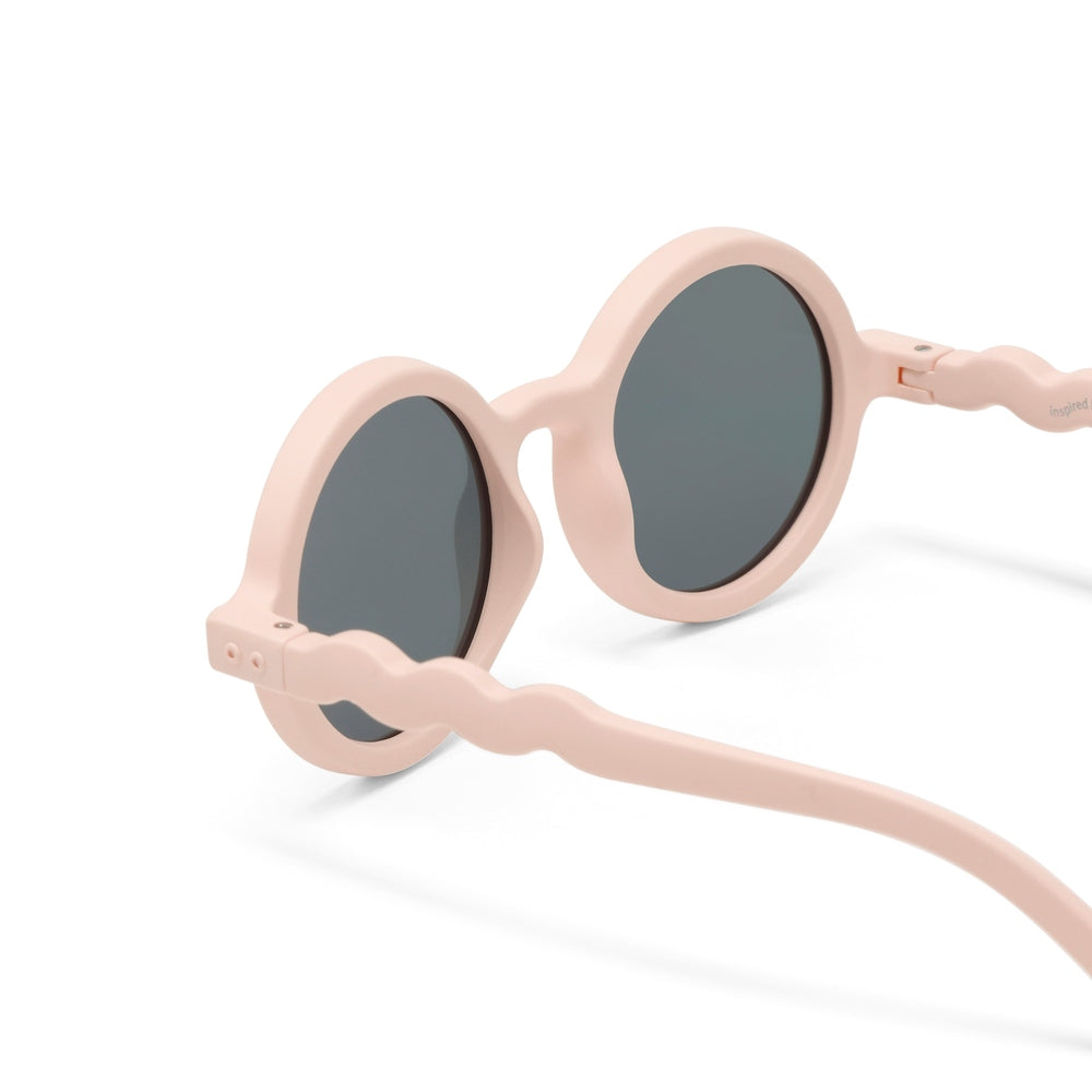 OLIVIO & CO Round Sunglasses Kids in shell pink with gray lenses, showing twisted temple arms.