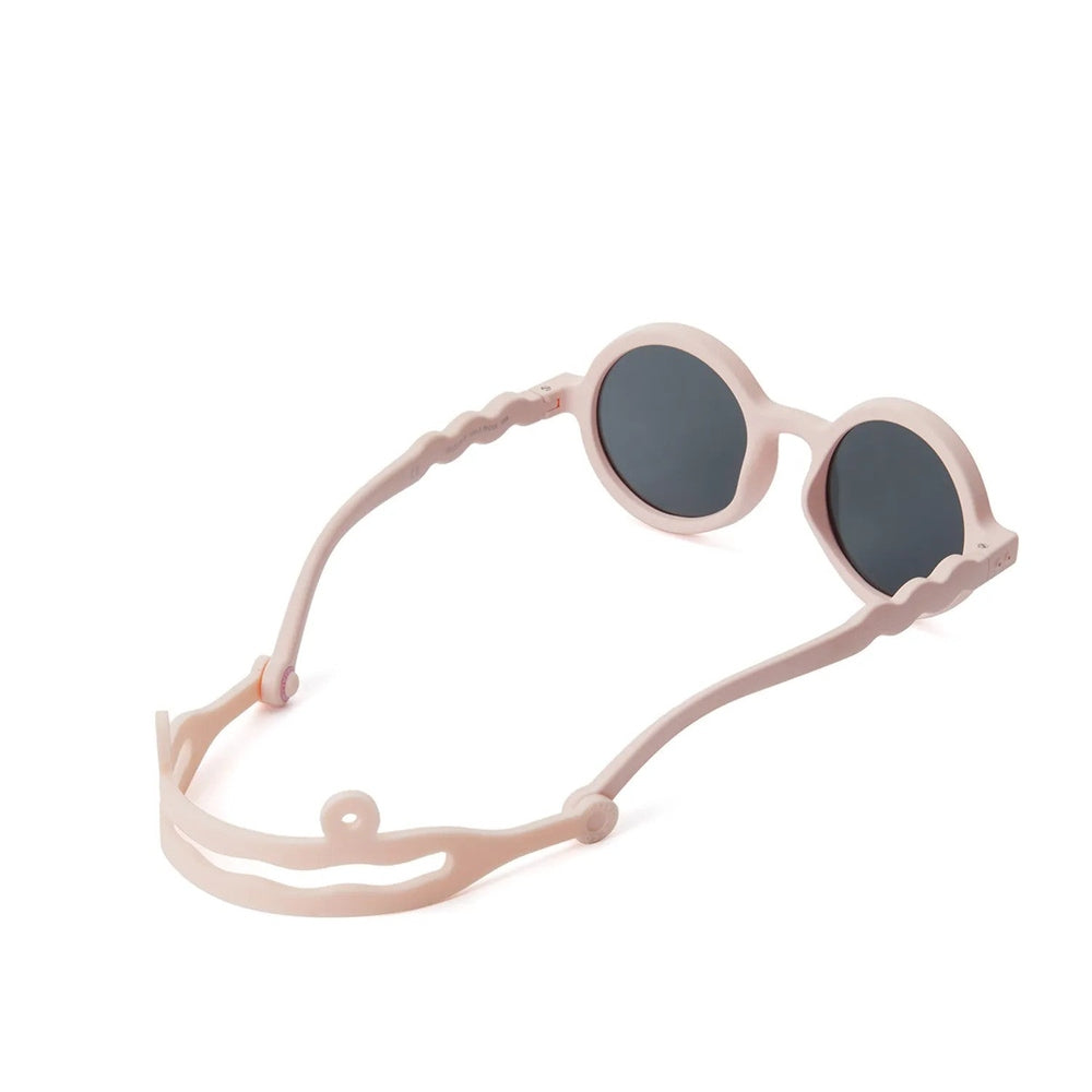 Olivio & Co Round Sunglasses Kids in coral blush with dark lenses, featuring an adjustable headband strap for secure fit.