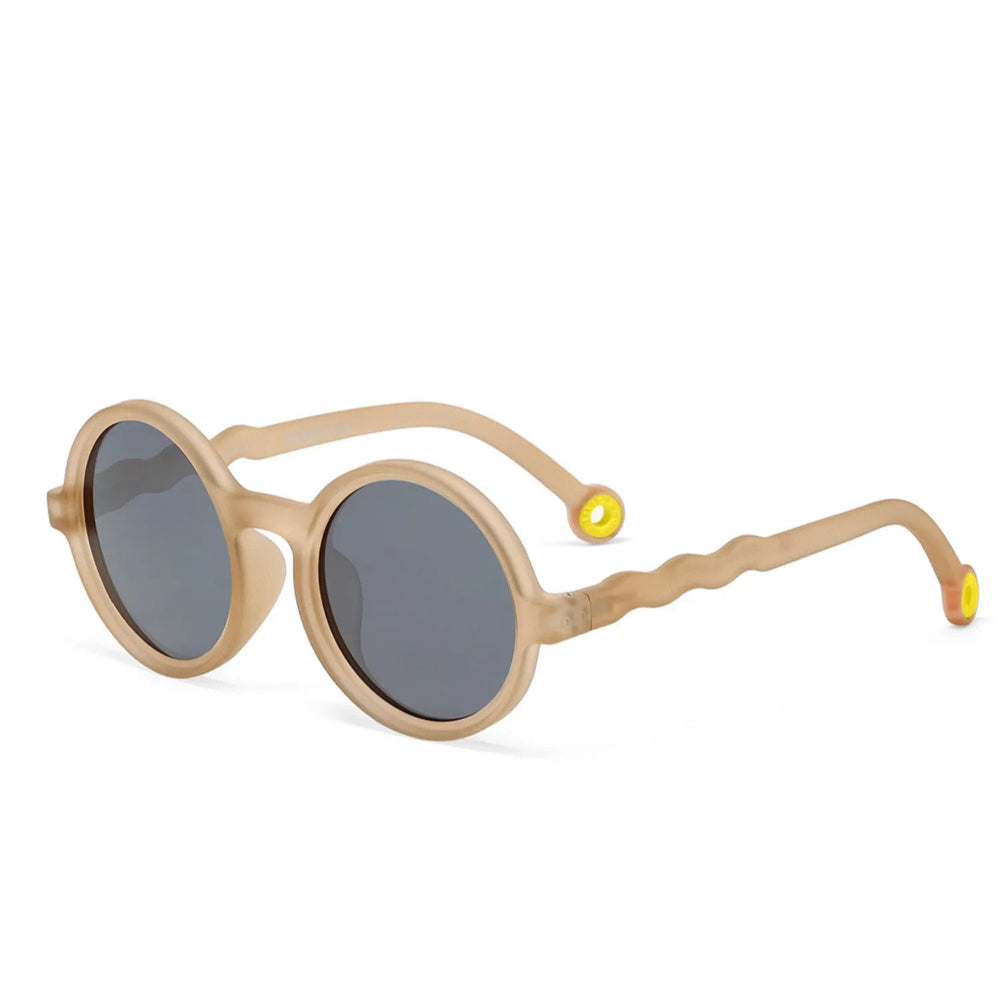Olivio & Co Round Sunglasses Kids, sand beige frame with grey lenses and yellow-tipped temples, displayed on white surface.