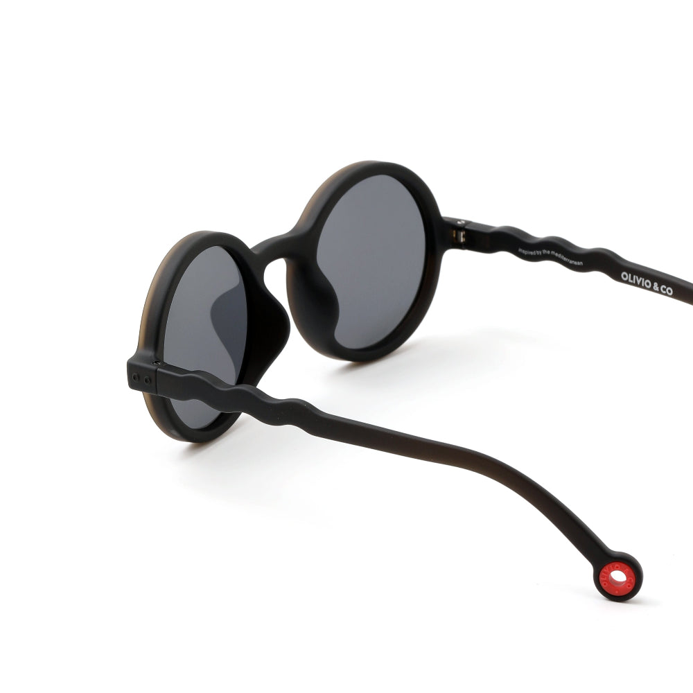 OLIVIO & CO Round Sunglasses for kids, black frame with wavy arms and red end-cap.