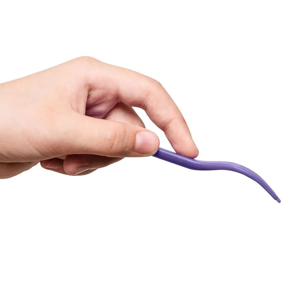 Omielife Fork Spoon Pod Set, purple silicone utensils being gently bent by hand to show flexibility.