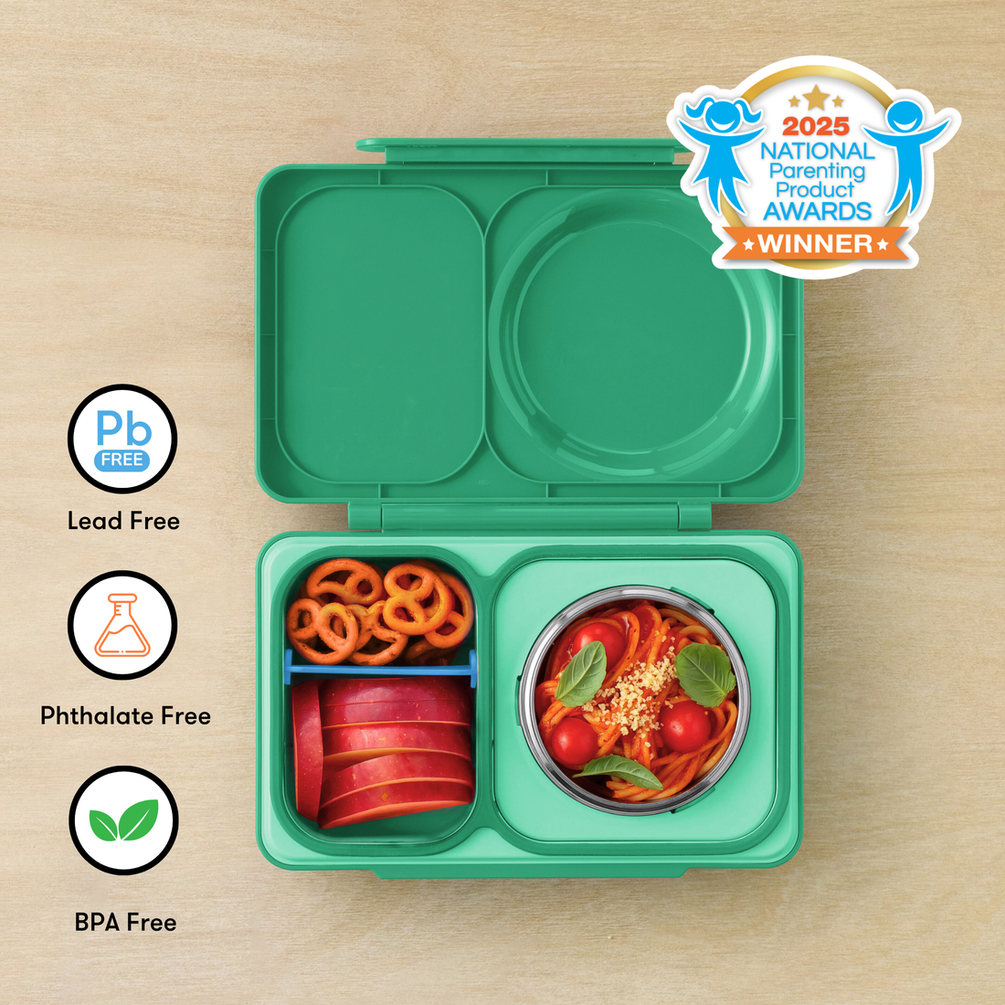 OmieBox UP Jade Green filled with pretzels, apple slices and pasta beside material-safety icons