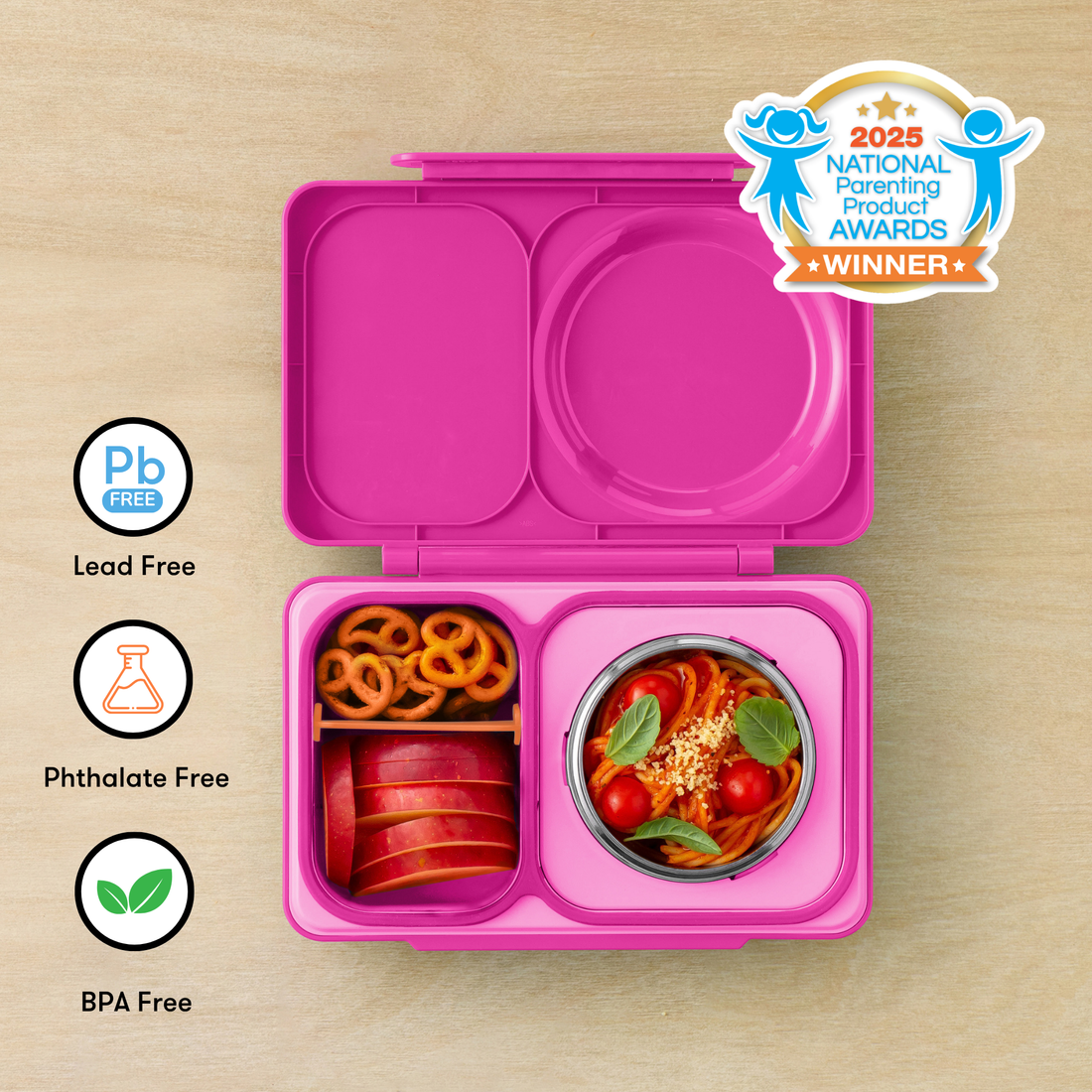 OmieBox UP Pop Pink filled with pretzels, apple slices and pasta beside material-safety icons
