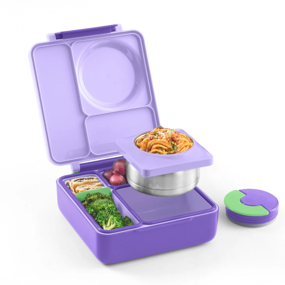 OmieBox Version 2 lunch box by OMIELIFE in purple, open to show stainless-steel insert and divided compartments with pasta in the top tray.