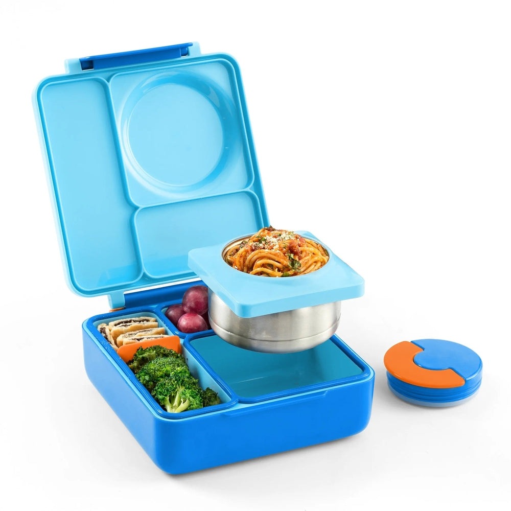 Omiebox Version 2 lunch box in blue with stainless steel inner bowl holding pasta atop divided compartments.