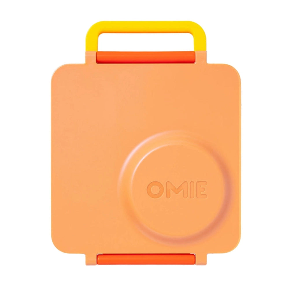 OmieBox Version 2 lunch box by OMIELIFE in orange with a yellow carry handle, ready to grab for school.