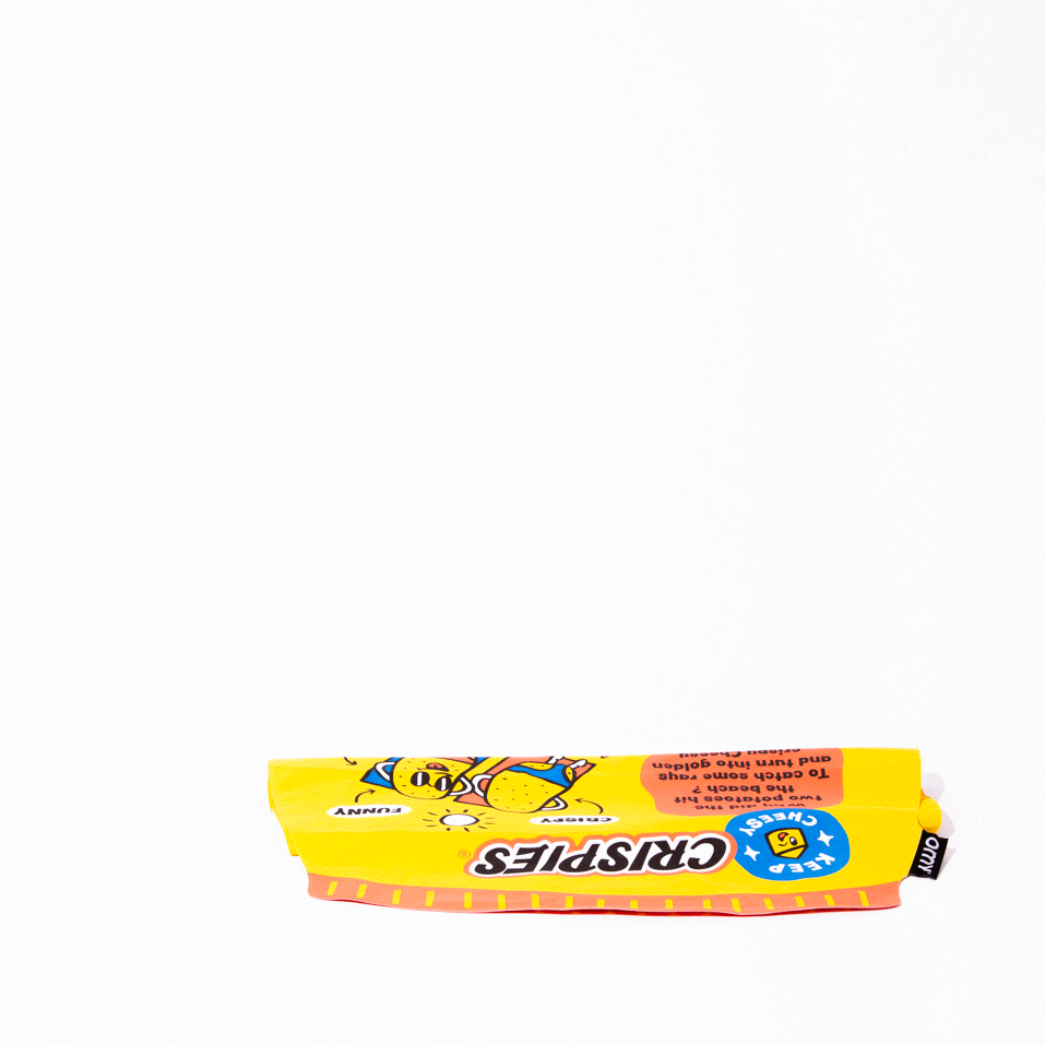 OMY Crispies Giant inflatable pillow in bright yellow packaging laid flat on a white background, tag visible.