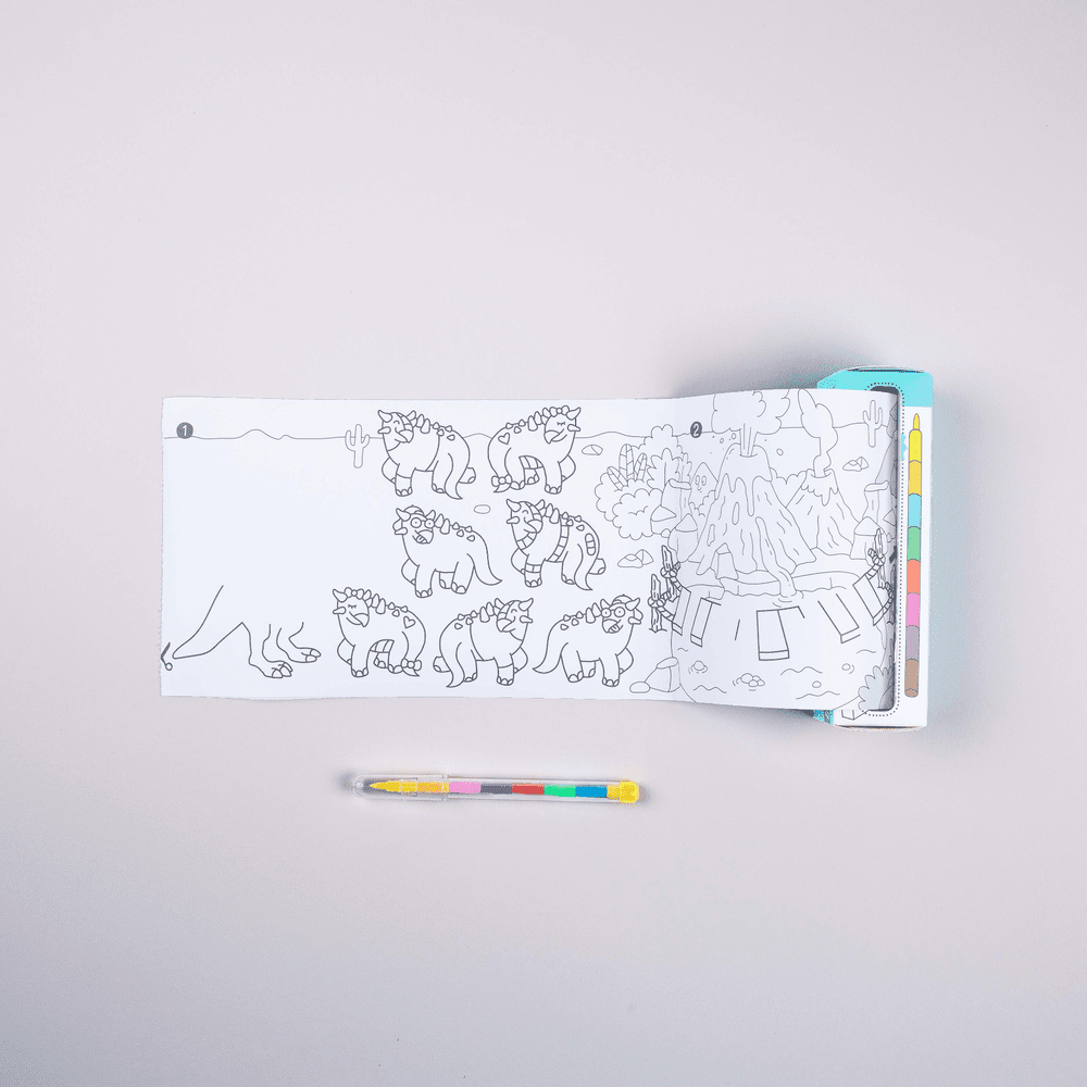 OMY Pocket Game Dino coloring book opened to a dinosaur scene; multicolor pencil set beside.