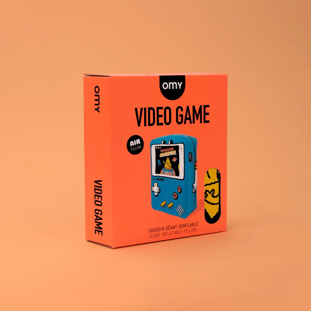 OMY Giant inflatable pillow Video Game, bright orange box with blue handheld console illustration.