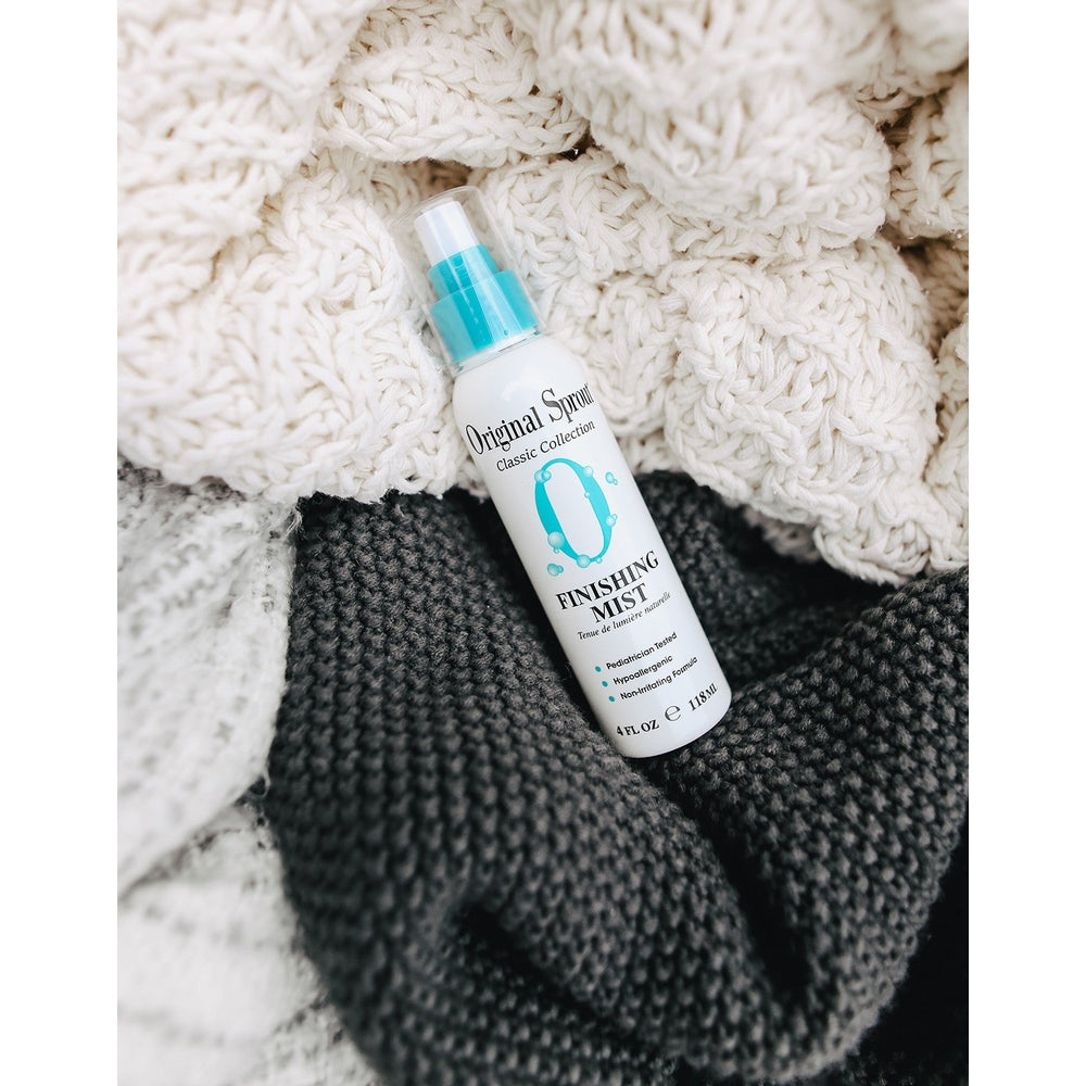 Original Sprout Classic Finishing Mist 4 oz bottle with turquoise spray pump resting on a cream knit blanket