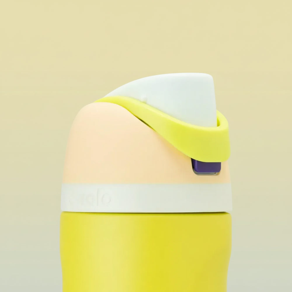 Owala FreeSip 24 oz Stainless Steel Water Bottle in Lemon Limeade — folded carry loop over the opening button
