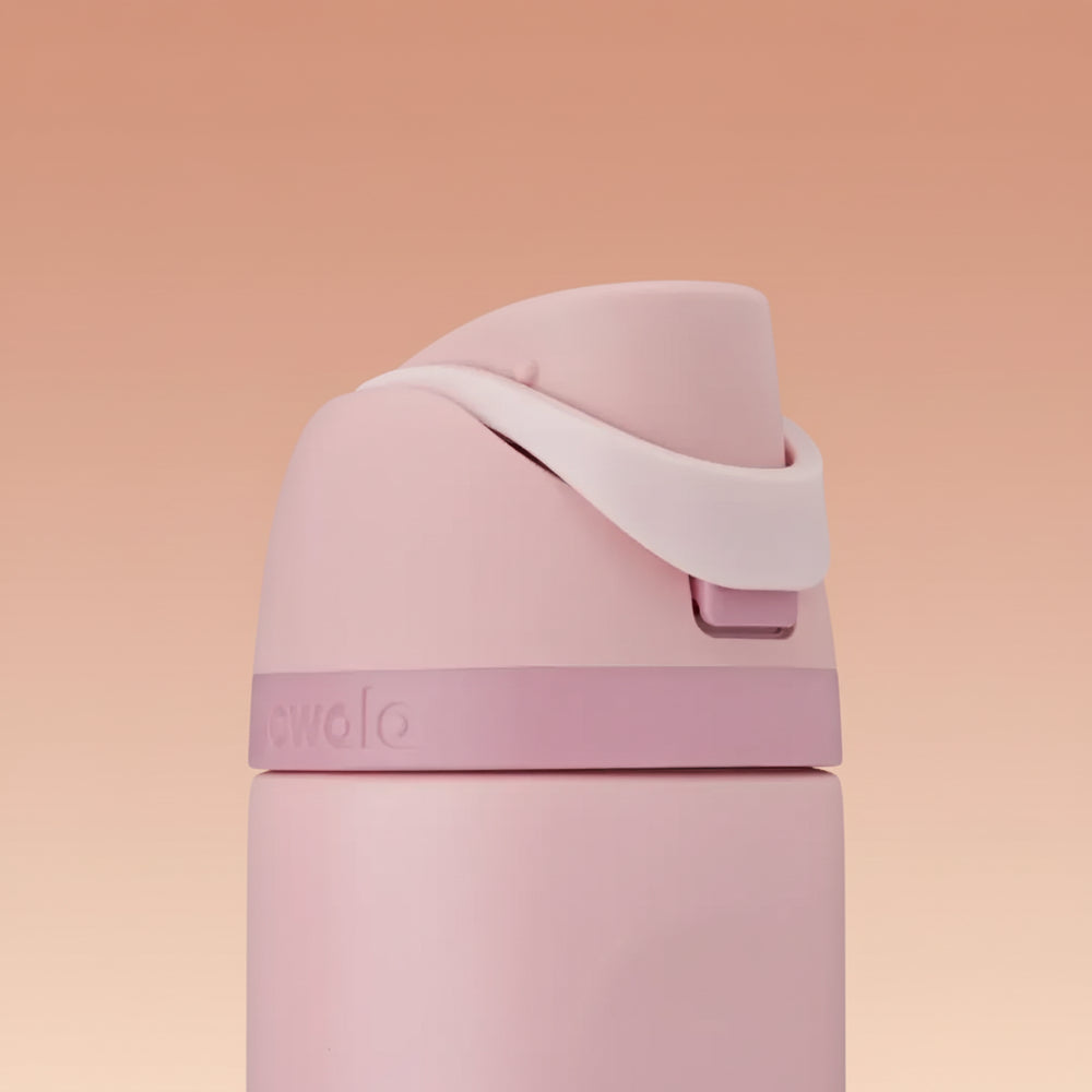 Owala FreeSip 24 oz Stainless Steel Water Bottle in Rose Quartz — folded carry loop over the opening button