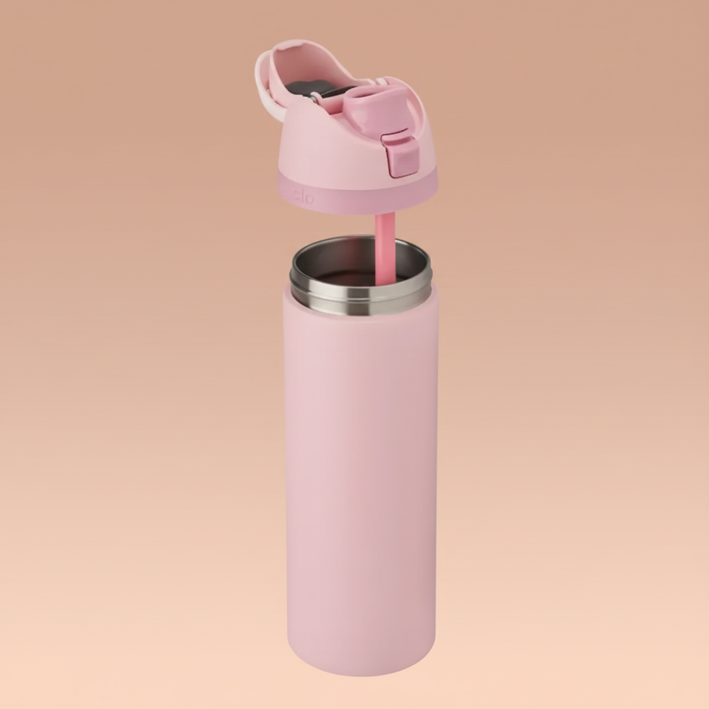 Pink water bottle with straw and lid on a white background