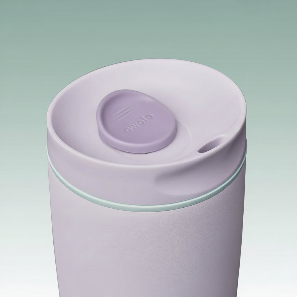 Purple tumbler with a lid on a white background