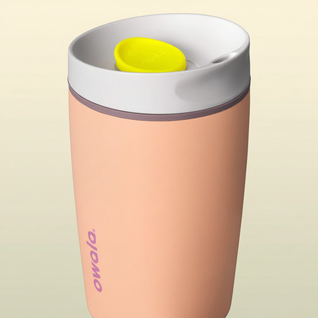 Pink tumbler with a white lid and yellow button on a white background