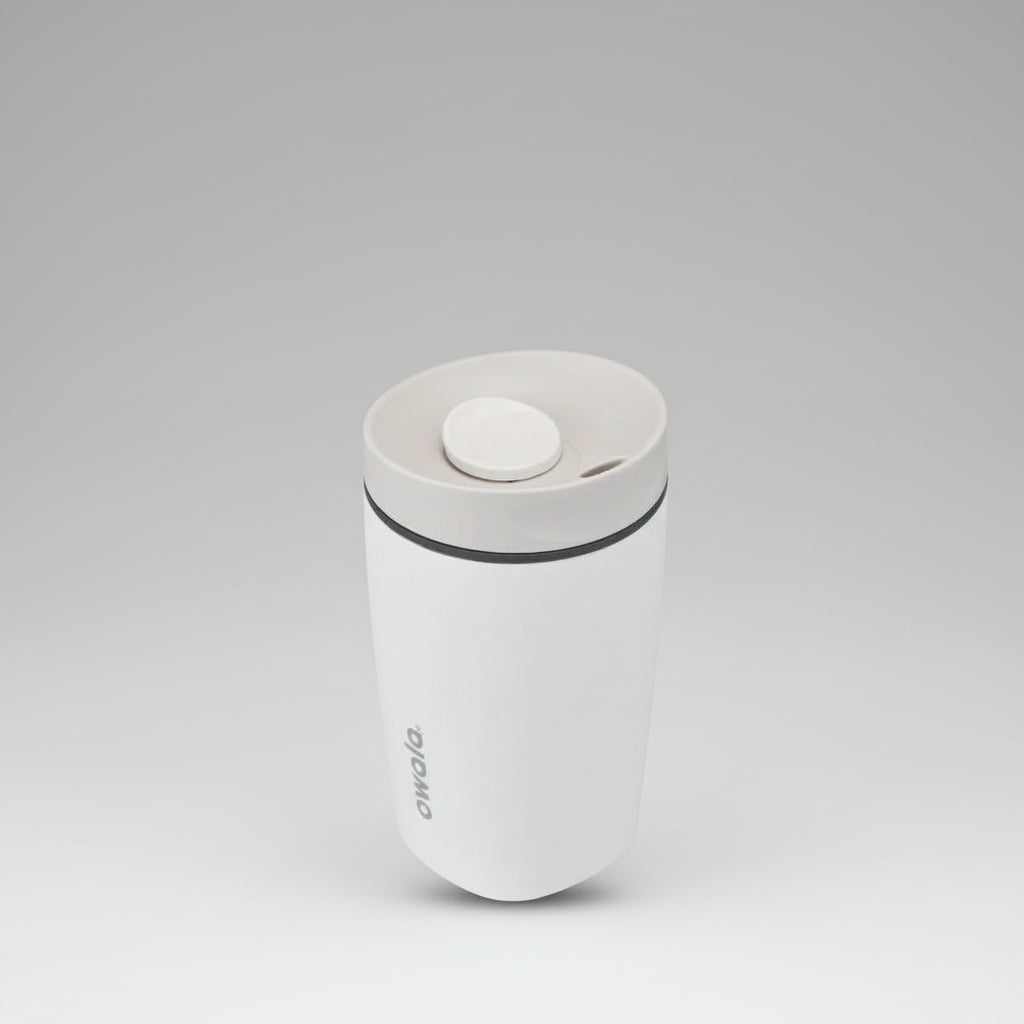 White tumbler with a lid on a white background