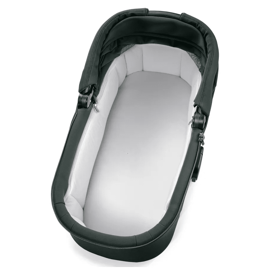 Peg Perego Culla Flex Bassinet with stand, dark green exterior and white interior cradling a newborn in a secure cradle