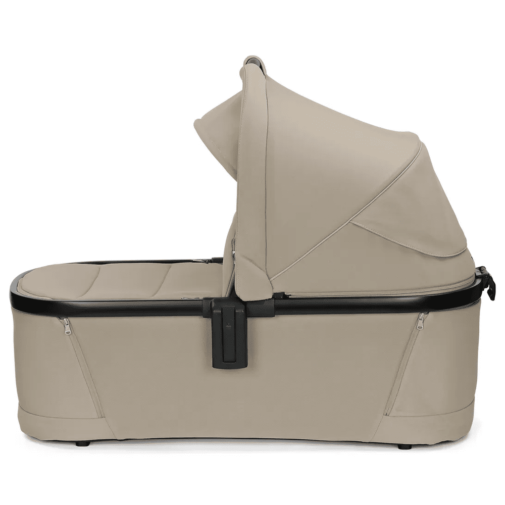 Peg Perego YPSI Bassinet with Stand By Me in beige, featuring a foldable canopy and secure side latch.
