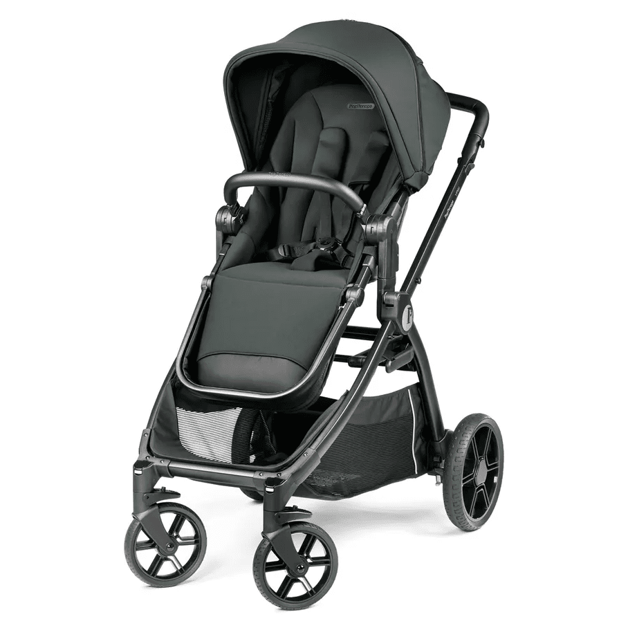 Peg Perego YPSI Stroller in dark green, child buckled into the seat with a 5-point harness under the canopy.