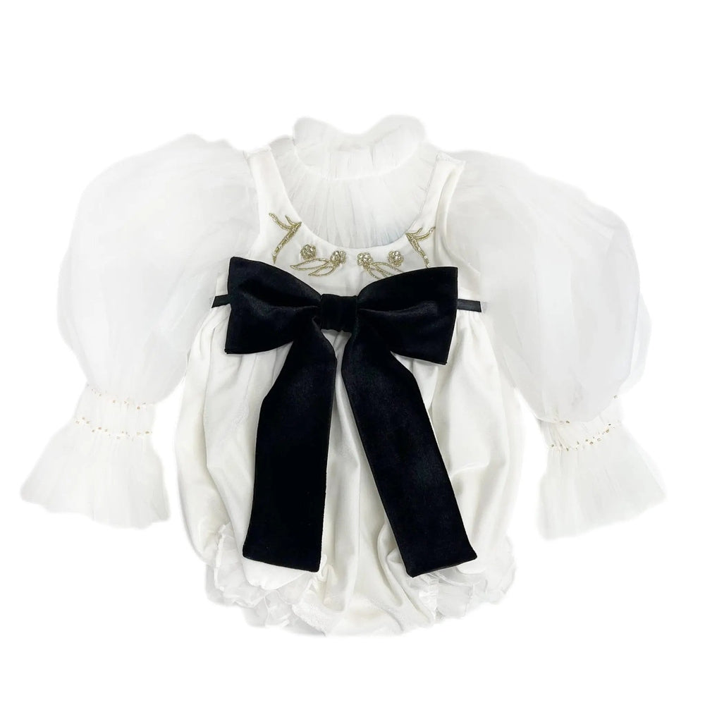 Petite Maison Kids Aurora Ivory Velour Romper with sheer puff sleeves and a large black bow tied at front.