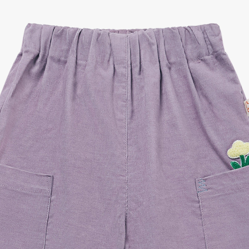 Petite Revery lilac corduroy baby pants with front pockets and embroidered flower detail.