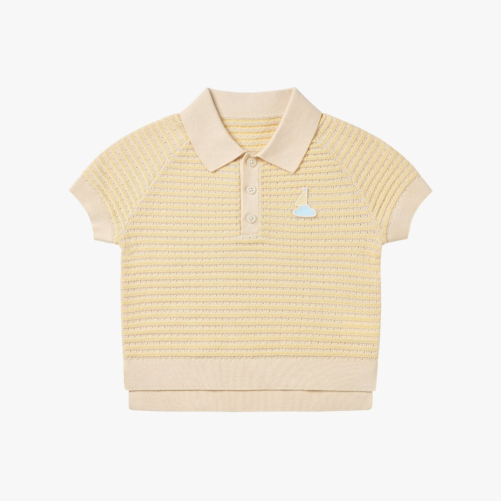 Petite Revery cotton knit short sleeve top in mellow yellow with polo collar and sailboat patch laid flat.