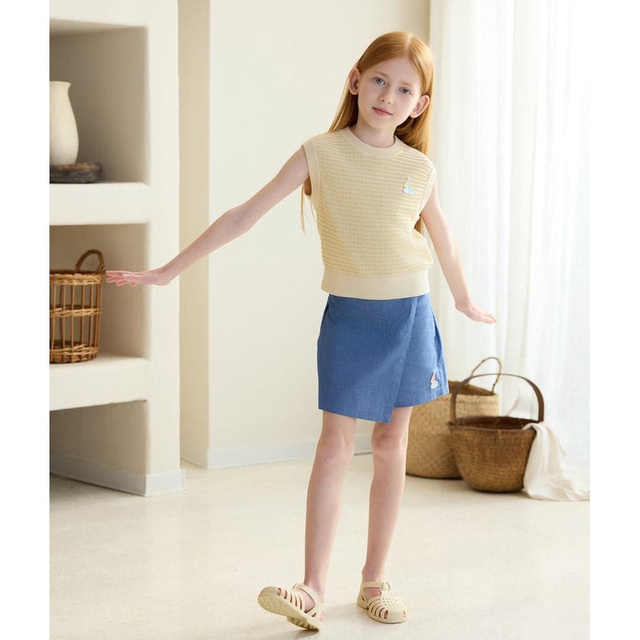 Petite Revery Cotton Knit Sleeveless Vest on a girl in mellow yellow, paired with blue shorts, as she stretches to show sleeveless design.