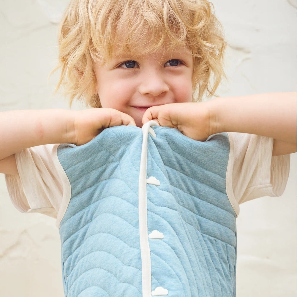 PETITE REVERY Petite Revery Quilted Reversible Vest Nimbus Cloud white piping trim with cloud-shaped snap closures img 2/9
