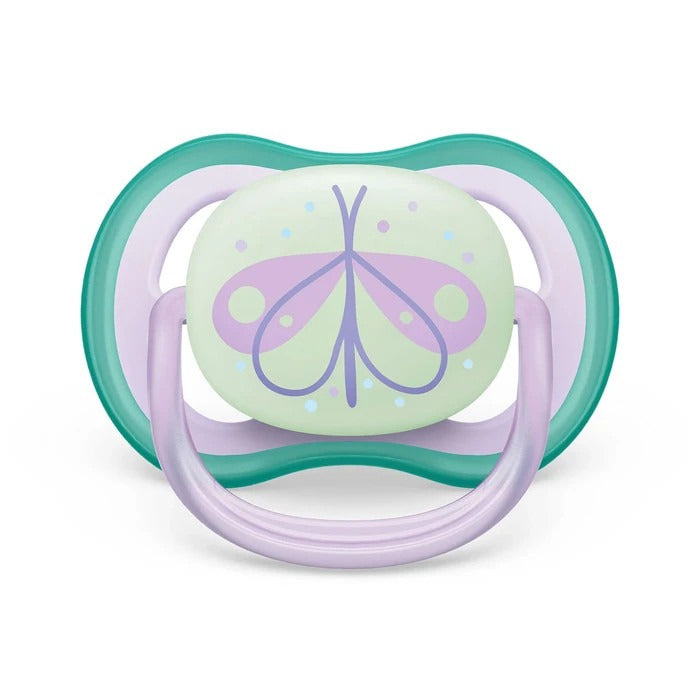 Mint-green pacifier with teal shield, lavender ring, and purple butterfly on center disk.