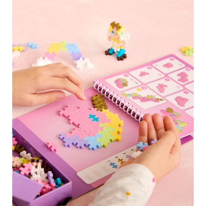PLUS-PLUS Activity Pad Fairy Tale 125pcs with pink spiral-bound pad, multicolor pixel blocks, and small figure