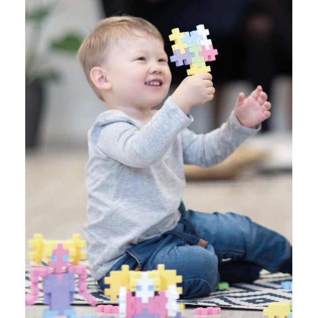 Plus-Plus Big Pastel Mix 100pcs building blocks in pastel colors; toddler playing.