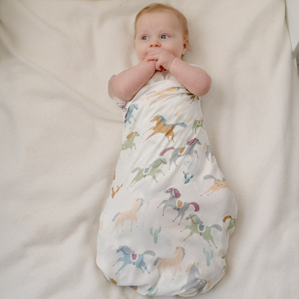 Nest Designs Pony Express Swaddle in White with pastel pony print